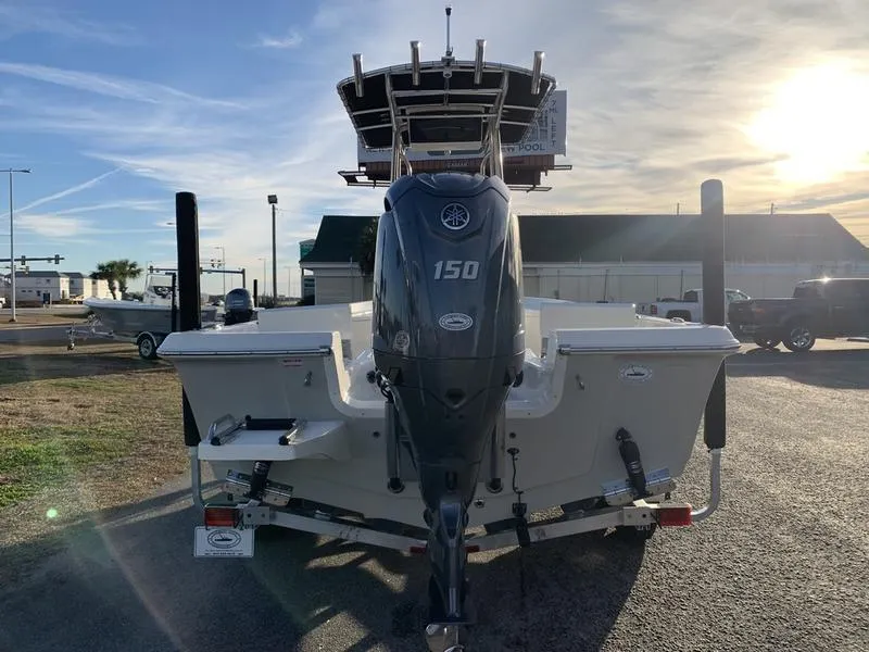 Slide: The Image of 2025 Bulls Bay 2200 XS boat with 150 HP engine, rear view in outdoor setting. - 3