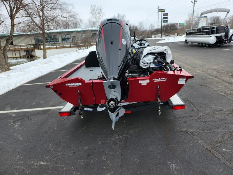 Slide: The Image of 2019 Tracker Pro Team 190 TX Tournament Edition boat, red, parked on snowy pavement. - 2