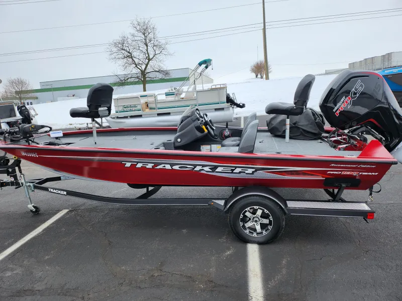 Slide: The Image of 2019 Tracker Pro Team 190 TX Tournament Edition boat, red, on trailer in parking lot. - 4