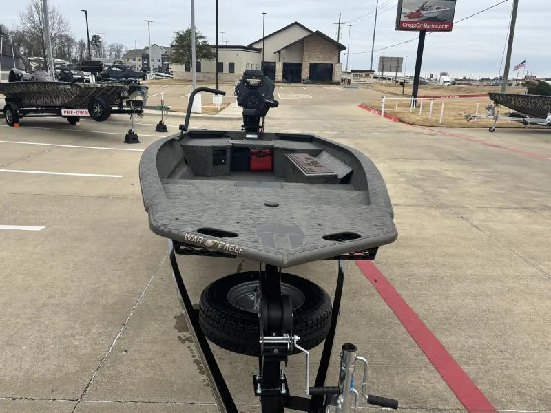 Slide: The Image of 2025 War Eagle 750 Gladiator boat on trailer in parking lot. - 1