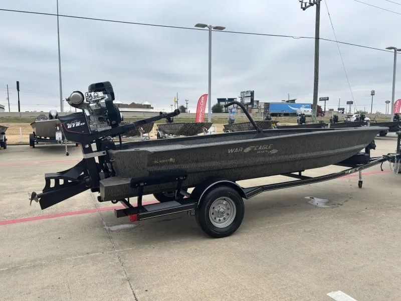 Slide: The Image of 2025 War Eagle 750 Gladiator boat on trailer in outdoor dealership lot. - 3