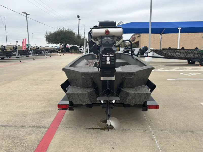 Slide: The Image of 2025 War Eagle 750 Gladiator boat with motor, parked in a lot. - 4