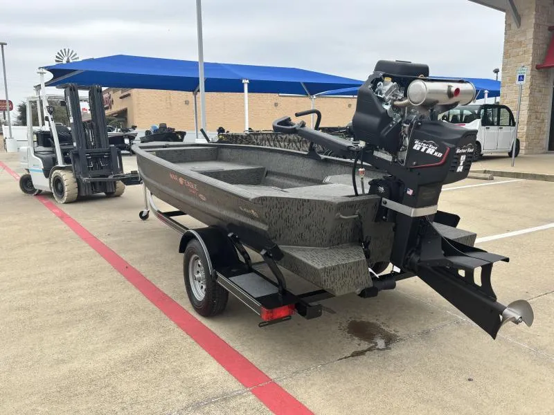 Slide: The Image of 2025 War Eagle 750 Gladiator boat on trailer, parked outdoors. - 5