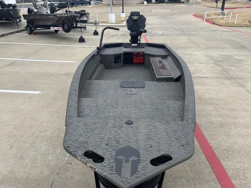 Slide: The Image of 2025 War Eagle 750 Gladiator boat in parking lot, showcasing interior and design. - 7