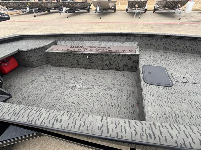 Slide: The Image of 2025 War Eagle 750 Gladiator boat interior with camouflage pattern and storage compartments. - 8
