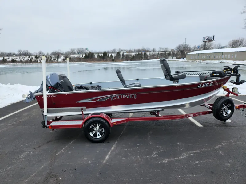 Slide: The Image of 2019 Lund 1600 Fury Tiller boat on trailer by a snowy lake. - 0