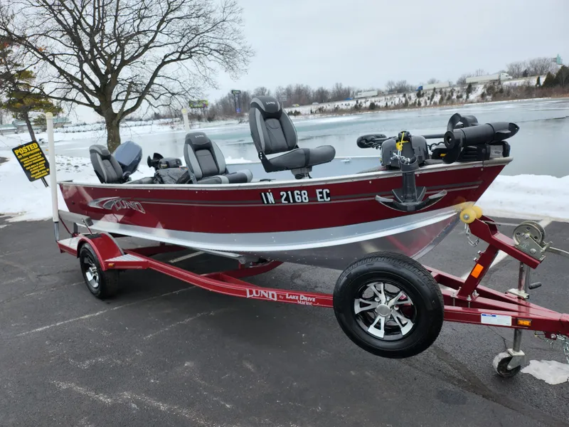 Slide: The Image of 2019 Lund 1600 Fury Tiller boat on trailer by a snowy lakeside. - 10