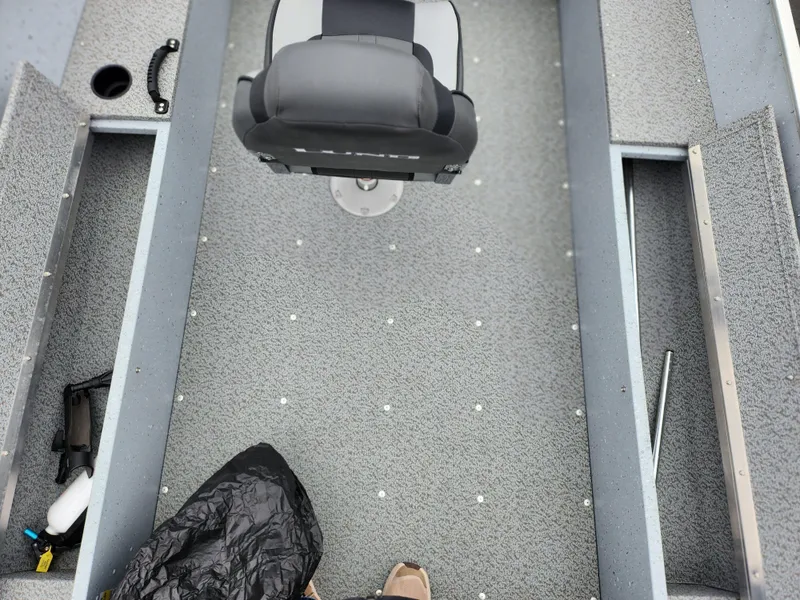 Slide: The Image of 2019 Lund 1600 Fury Tiller boat interior with gray carpet and seating. - 17