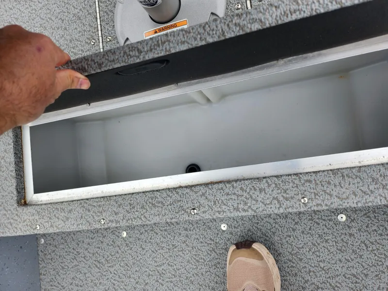 Slide: The Image of 2019 Lund 1600 Fury Tiller boat storage compartment, open and empty. - 18