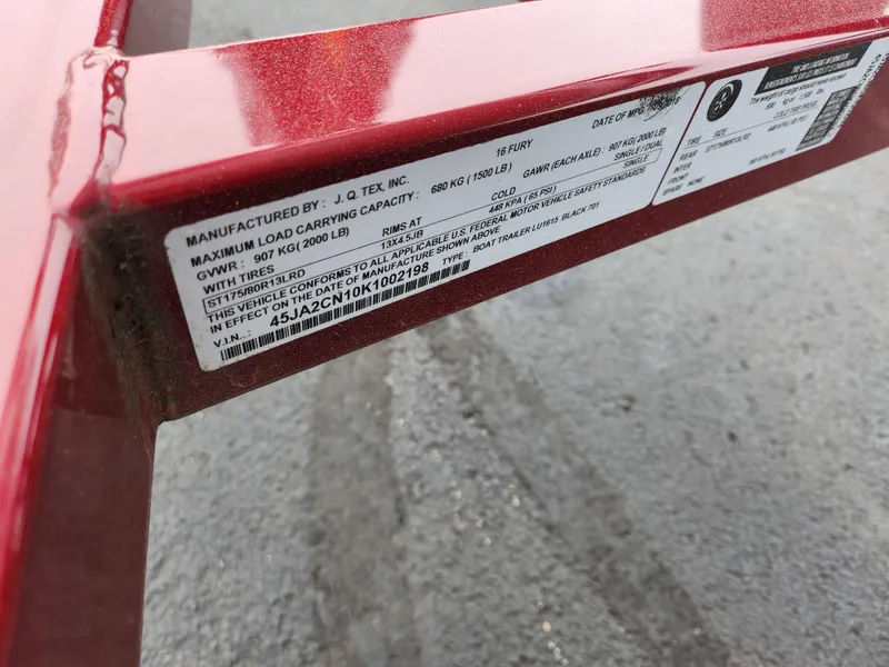 Slide: The Image of Label on a red 2019 Lund 1600 Fury Tiller, showing specifications and load capacity. - 9