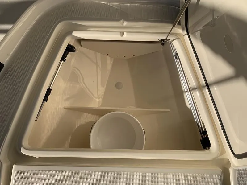 Slide: The Image of 2025 Scout 177 Sport boat with open storage compartment and speakers. - 12