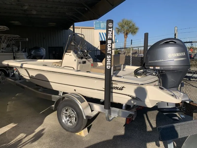 The Image of 2025 Scout 177 Sport boat on trailer at authorized dealer showroom. - 2
