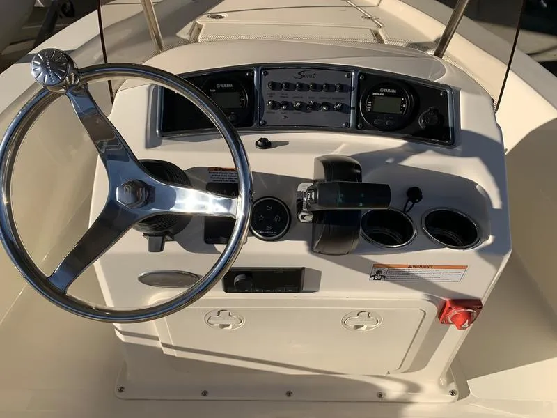 Slide: The Image of 2025 Scout 177 Sport boat interior with steering wheel and control panel. - 6