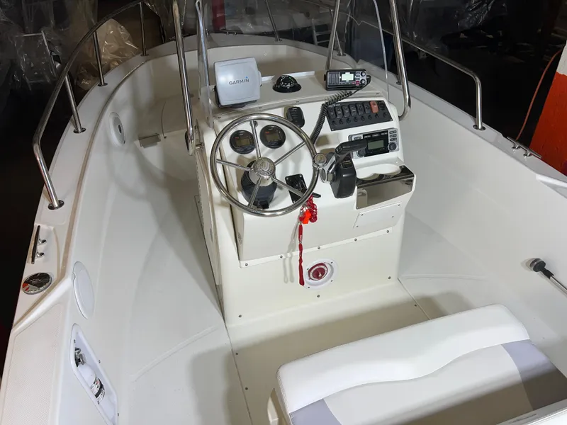 Slide: The Image of 2011 Edgewater 170CC boat interior with steering wheel and control panel. - 10