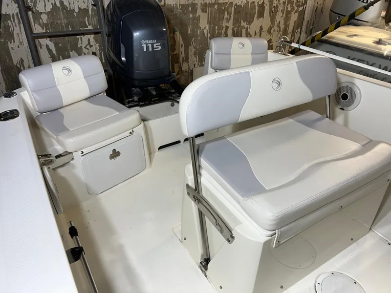 Slide: The Image of 2011 Edgewater 170CC boat interior with Yamaha 115 engine, featuring white cushioned seating. - 11