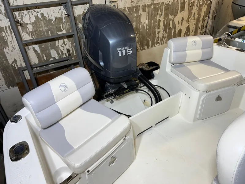 Slide: The Image of 2011 Edgewater 170CC boat interior with Yamaha 115 engine, featuring cushioned seating. - 12