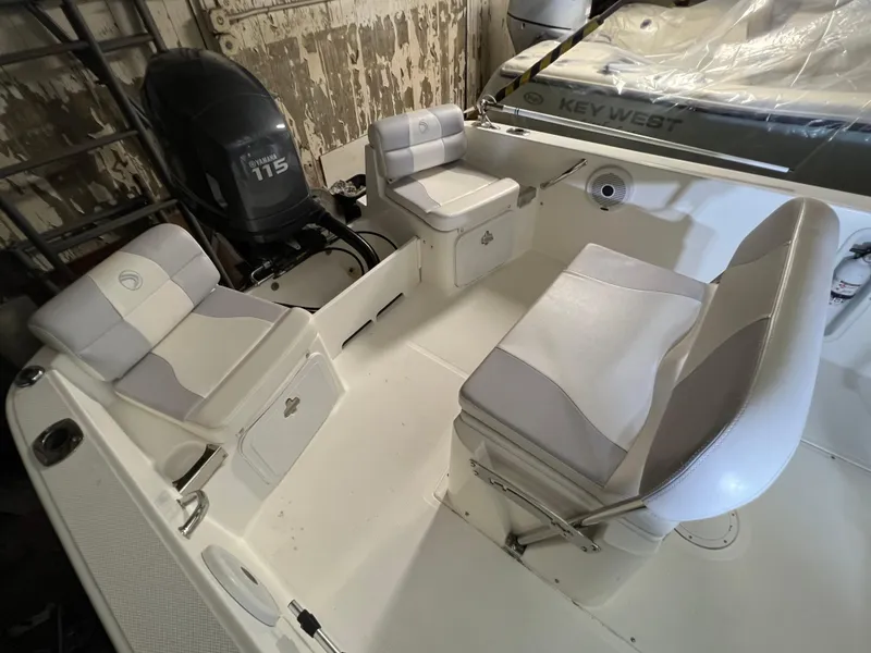 Slide: The Image of 2011 Edgewater 170CC boat interior with seating and Yamaha 115 outboard motor. - 13