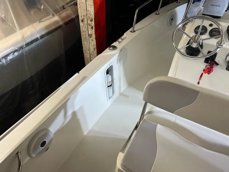 Slide: The Image of 2011 Edgewater 170CC boat interior with steering wheel and seating. - 14