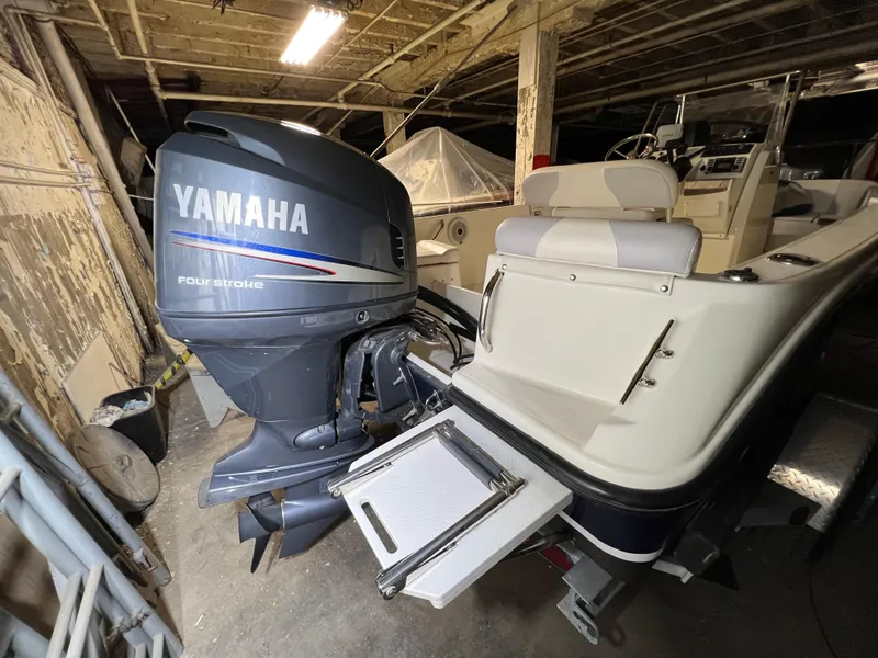 Slide: The Image of 2011 Edgewater 170CC boat with Yamaha four-stroke engine in a rustic garage setting. - 15