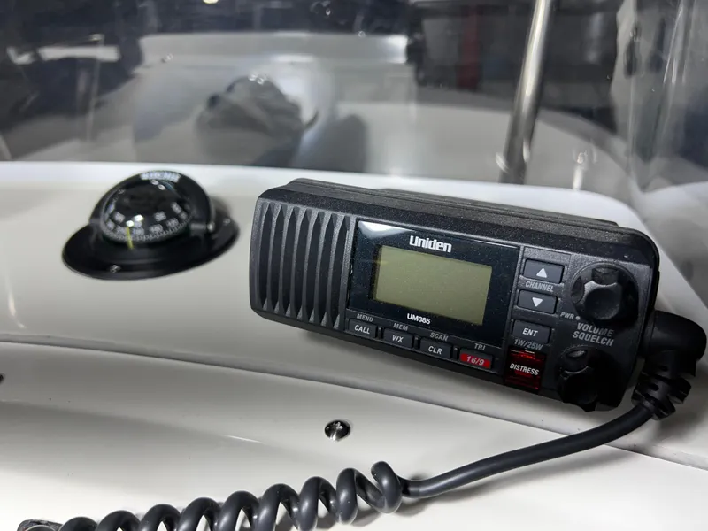 Slide: The Image of Uniden marine radio and compass on 2011 Edgewater 170CC boat dashboard. - 16