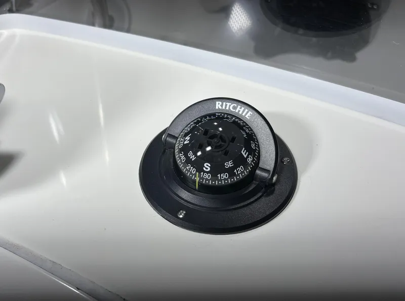 Slide: The Image of Ritchie compass on 2011 Edgewater 170CC boat dashboard. - 18