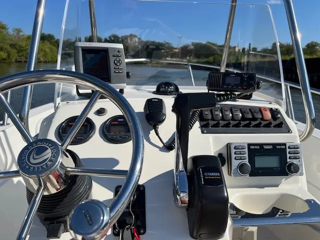 Slide: The Image of Edgewater 170CC 2011 boat dashboard with steering wheel, gauges, and navigation equipment. - 2