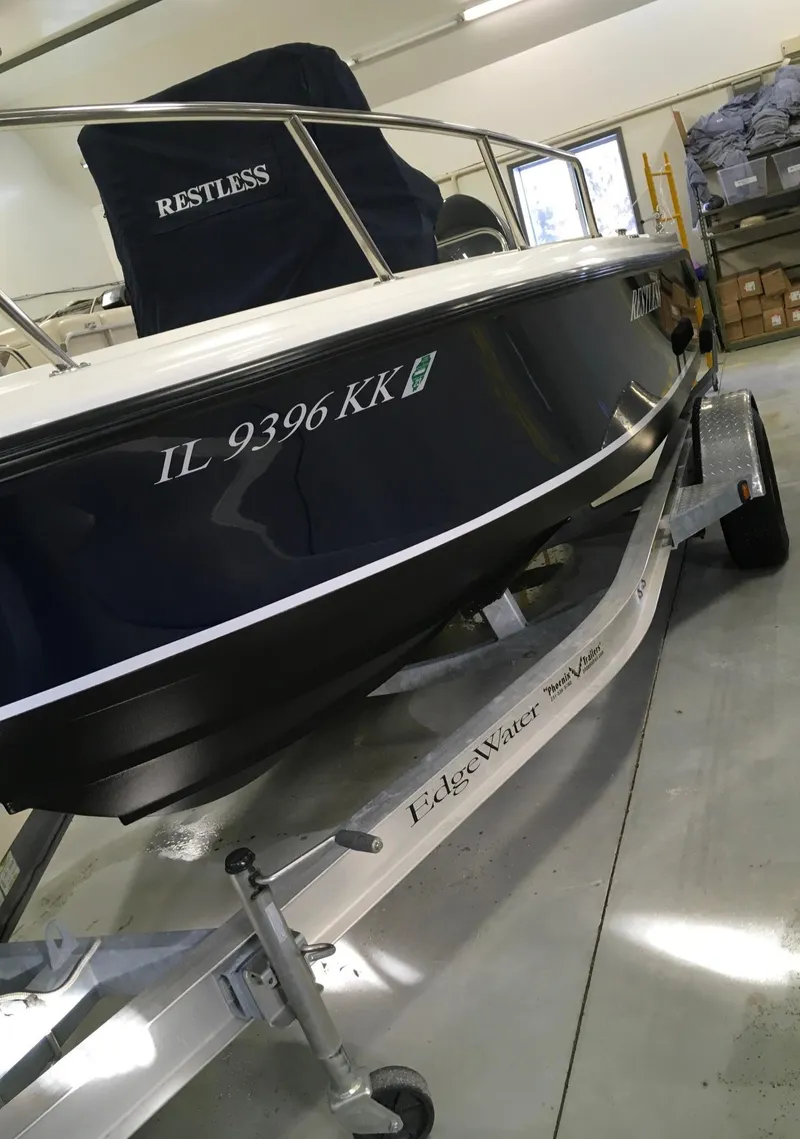 Slide: The Image of 2011 Edgewater 170CC boat on trailer in indoor storage. - 5