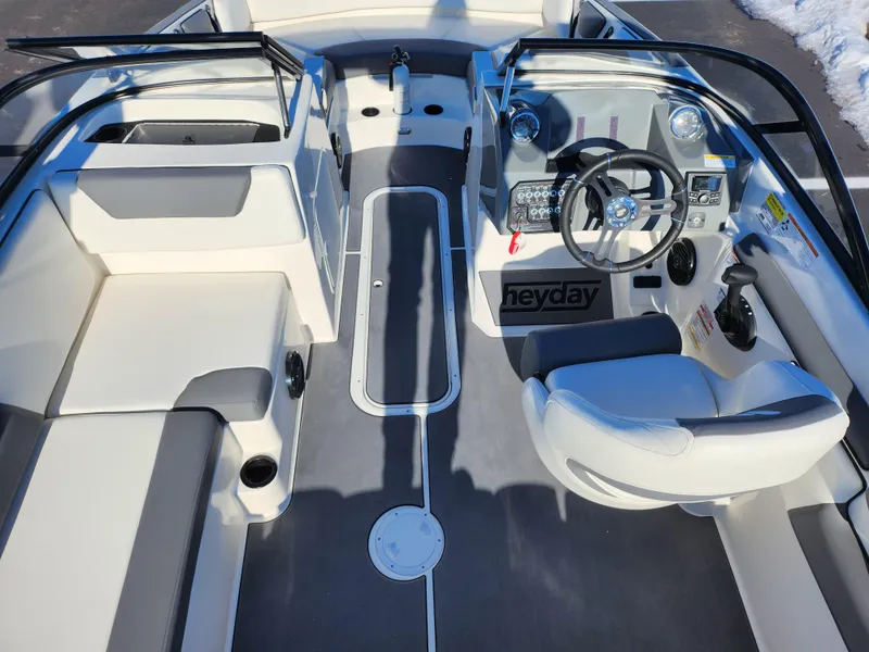 Slide: The Image of 2019 Heyday WT-2DC boat interior with steering wheel and seating. - 12