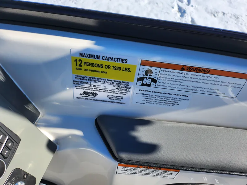 Slide: The Image of 2019 Heyday WT-2DC boat capacity label, maximum 12 persons or 1920 lbs, safety warnings visible. - 14