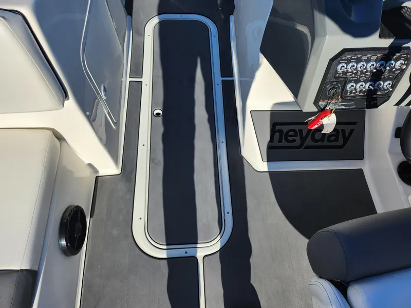 Slide: The Image of Interior of a 2019 Heyday WT-2DC boat showing seating and control panel. - 15