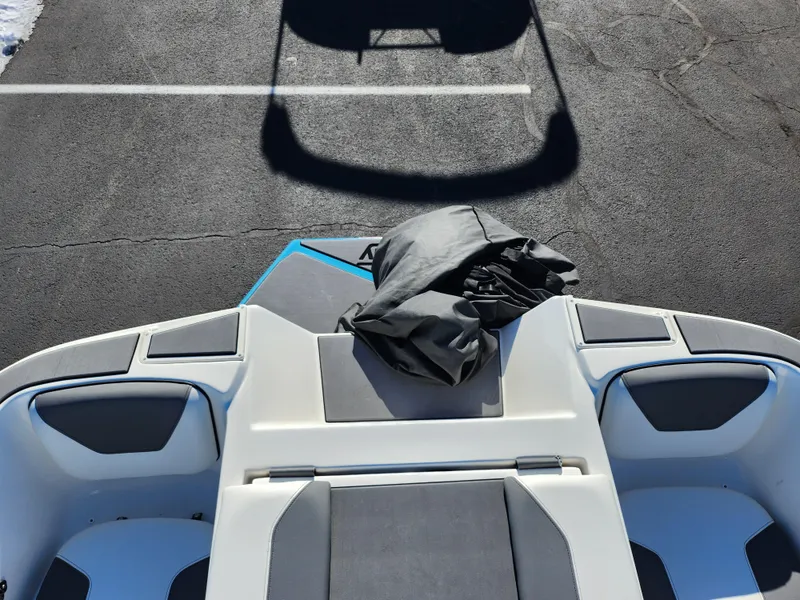 Slide: The Image of 2019 Heyday WT-2DC boat interior with seating and cover, parked on asphalt. - 24