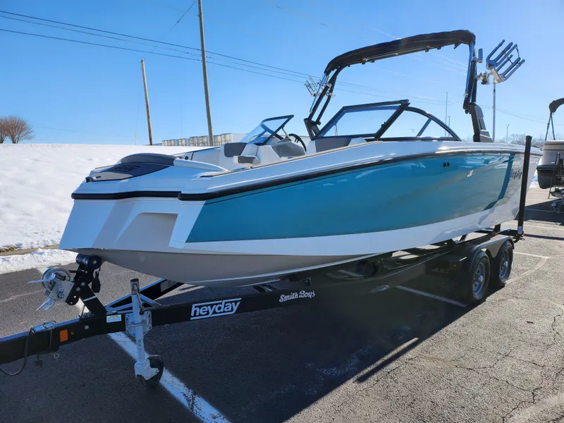 Slide: The Image of 2019 Heyday WT-2DC boat on trailer, blue and white design, parked outdoors. - 5