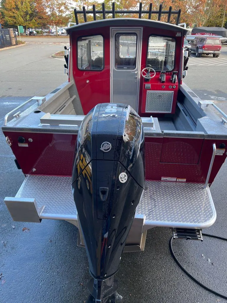 Slide: The Image of 2024 Spartan Maximus 240 boat with powerful outboard motor, red cabin, and spacious deck. - 4