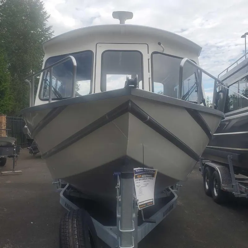 Slide: The Image of 2024 Spartan Maximus 240 boat on trailer, front view, outdoors. - 5