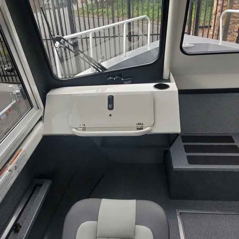 Slide: The Image of 2024 Spartan Maximus 240 boat interior with seating and storage compartment. - 9