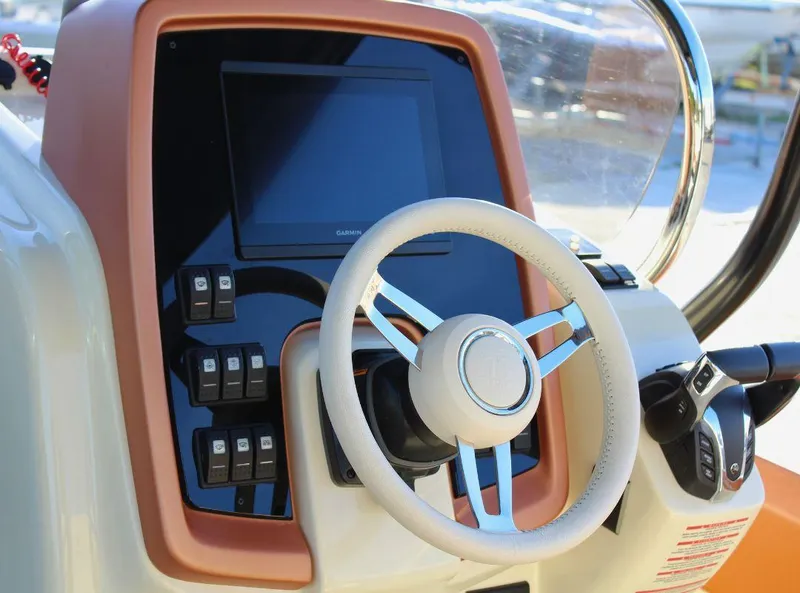 Slide: The Image of 2024 Capoforte FX270 boat dashboard with steering wheel and control panel. - 11