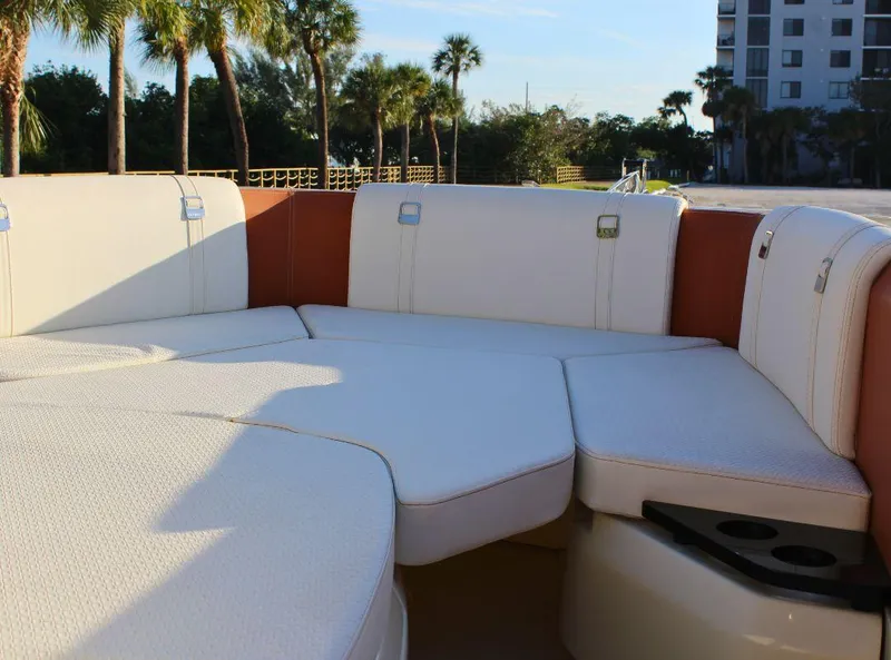 Slide: The Image of 2024 Capoforte FX270 boat interior with white cushioned seating and cup holders. - 14
