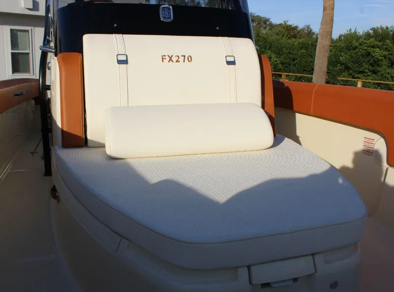 Slide: The Image of 2024 Capoforte FX270 boat seat with white upholstery and brown accents. - 15