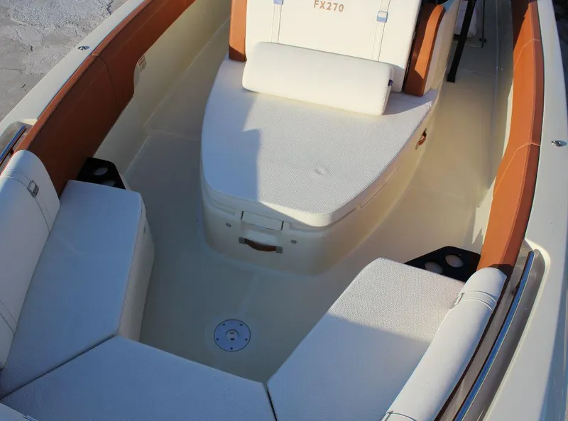 Slide: The Image of 2024 Capoforte FX270 boat interior with white and tan seating, showcasing luxury design. - 16
