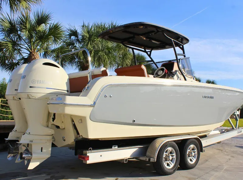 Slide: The Image of 2024 Capoforte FX270 boat on trailer, featuring dual Yamaha engines, parked near palm trees. - 3