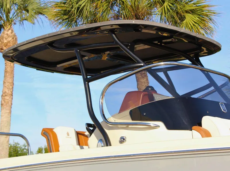 Slide: The Image of 2024 Capoforte FX270 boat with sleek design and modern canopy against palm trees. - 6