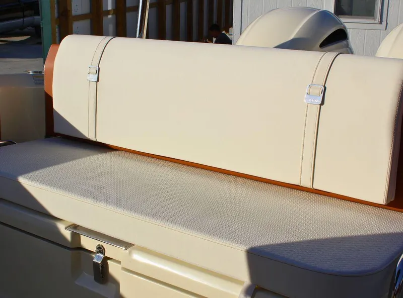 Slide: The Image of 2024 Capoforte FX270 boat seat with beige upholstery and storage compartment. - 8