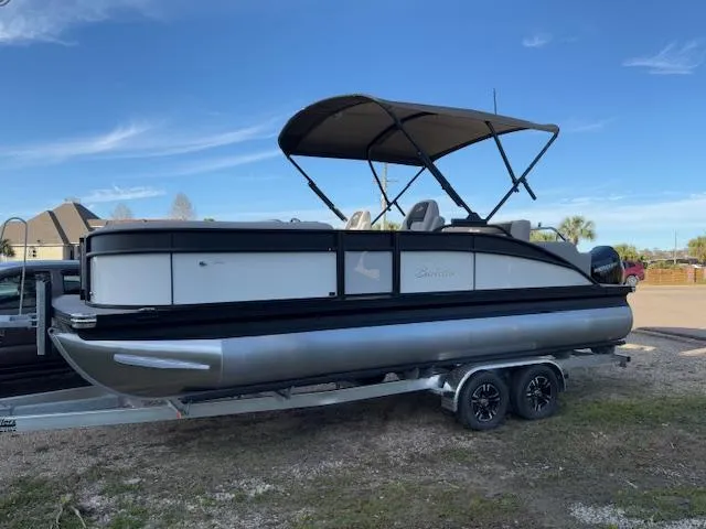 Slide: The Image of 2025 Barletta ARIA 22UC pontoon boat on trailer, featuring a canopy. - 1