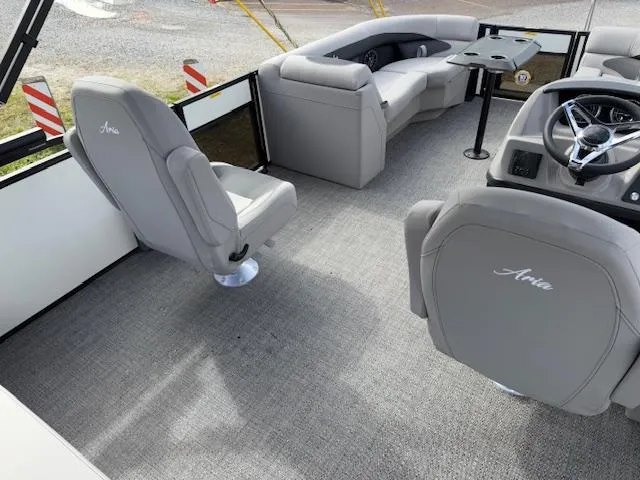 Slide: The Image of 2025 Barletta ARIA 22UC boat interior with gray seating and steering console. - 10