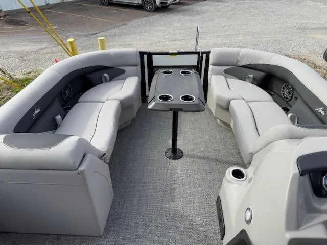 Slide: The Image of 2025 Barletta ARIA 22UC pontoon boat interior with plush seating and central table. - 14