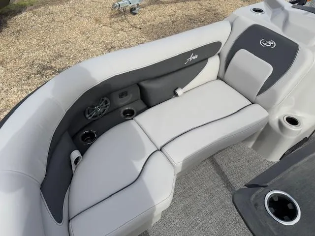 Slide: The Image of 2025 Barletta ARIA 22UC boat interior with plush seating and cup holders. - 15