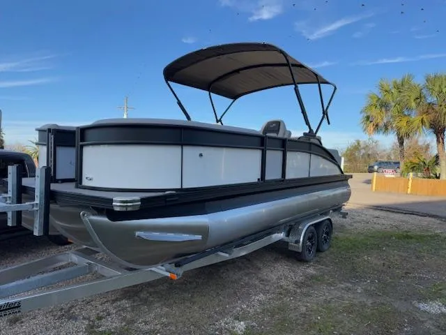 Slide: The Image of 2025 Barletta ARIA 22UC pontoon boat on trailer, featuring a sleek design and canopy. - 5