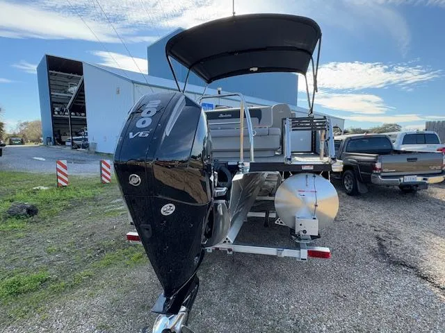 Slide: The Image of 2025 Barletta ARIA 22UC pontoon boat with powerful V6 engine, parked outdoors. - 6