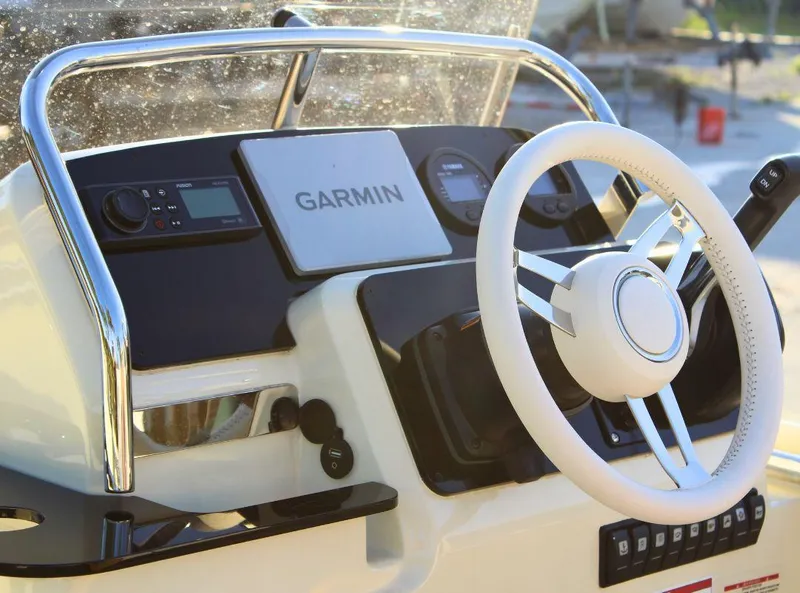 Slide: The Image of 2024 Capoforte SX200 boat dashboard with Garmin navigation system and steering wheel. - 10