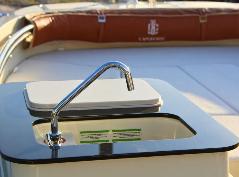 Slide: The Image of 2024 Capoforte SX200 boat sink with chrome faucet and cushioned seating. - 15